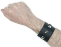 Black leather bracelet with single row of studs which completes a punk look from the 70s and 80s